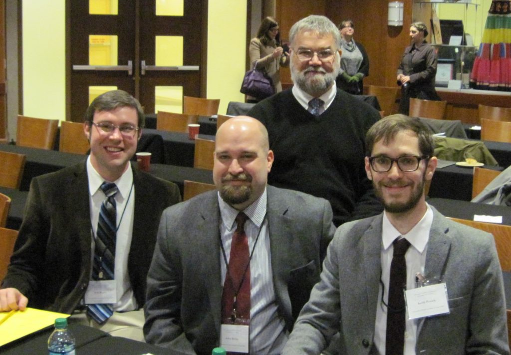 Will Begley, John Beeby, and Keith Penich (front, l-r), presented their work from Bob Babcock's Latin paleography class at the Texts and Contexts conference. Prof. Babcock (back) chaired the students' discussion of the origins of eleventh-century manuscripts from Gembloux, a Belgian abbey. 